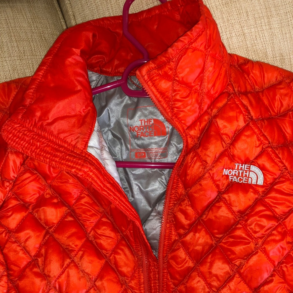 Orange North Face Down Puffer Jacket.